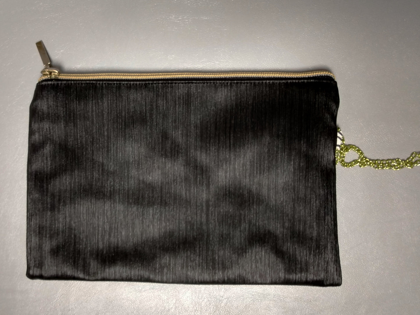 Arrière de la pochette Bonidé sans noeud. Elle est en simili cuir noir. On voit la dragonne sur le côté droit et la fermeture éclair fermée.