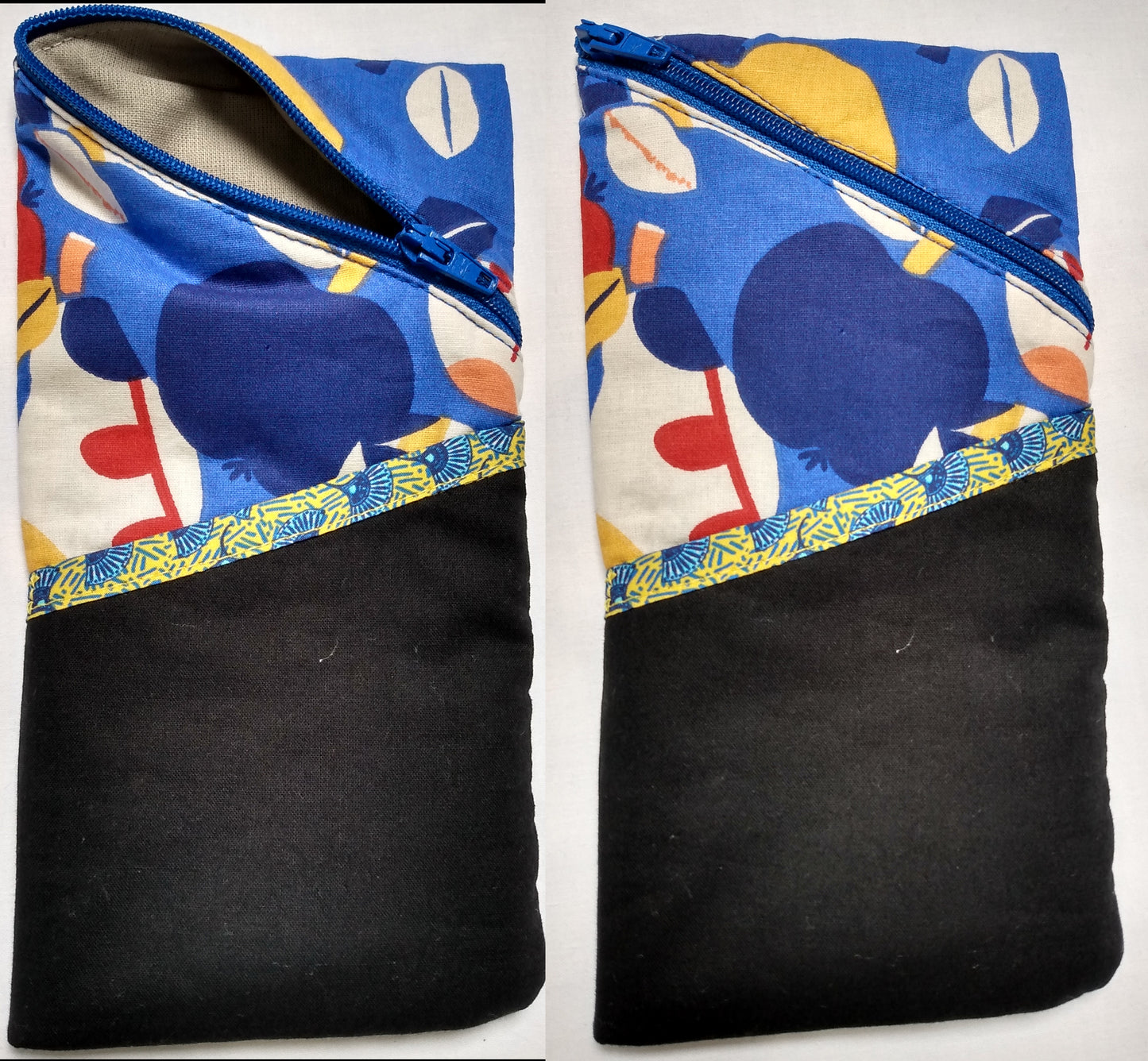 Étui à lunettes motifs pommes multicolore sur fond bleu. Se ferme avec un zip bleu. A l'extérieur, une poche noire ouverte, surmontée d'un biais jaune motif éventails bleus est visible à l'avant, sur la moitié basse de l'étui. L'intérieur est uni gris.